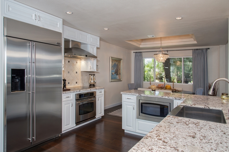 Scottsdale design-build remodeling of this kitchen with white cabinets and granite countertops