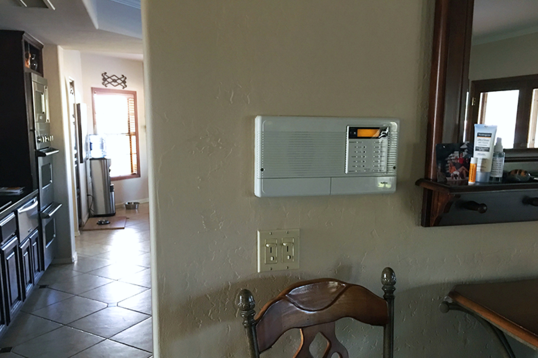 Original wall divider with intercom panel between the kitchen and family room in the Phoenix home.