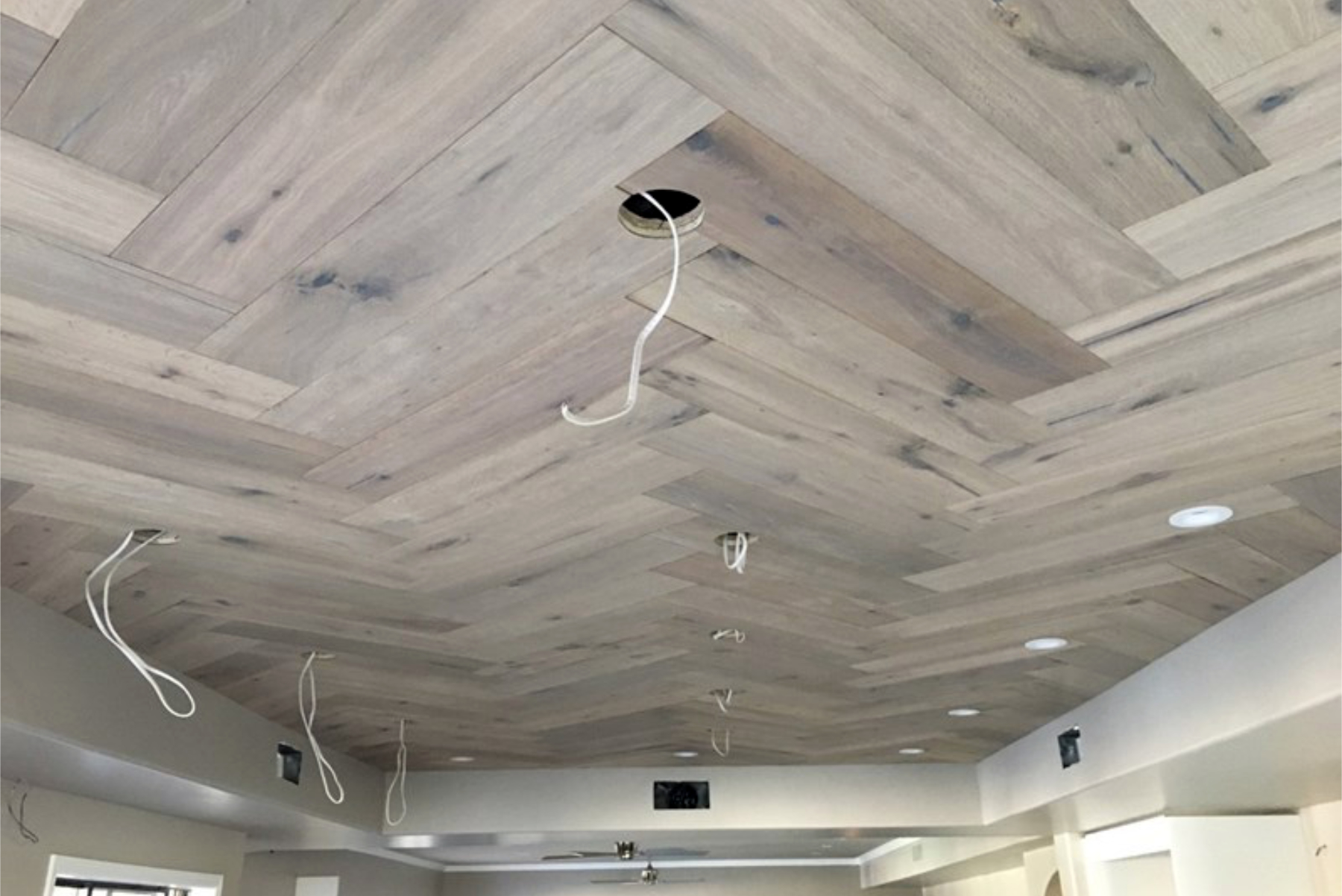 Herringbone French White Oak ceiling installation in progress at the Phoenix wood-ceiling kitchen.